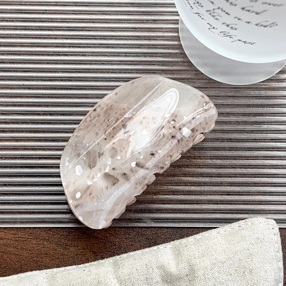 Hårklemme i beige terrazzo med brune og hvide brudstykker