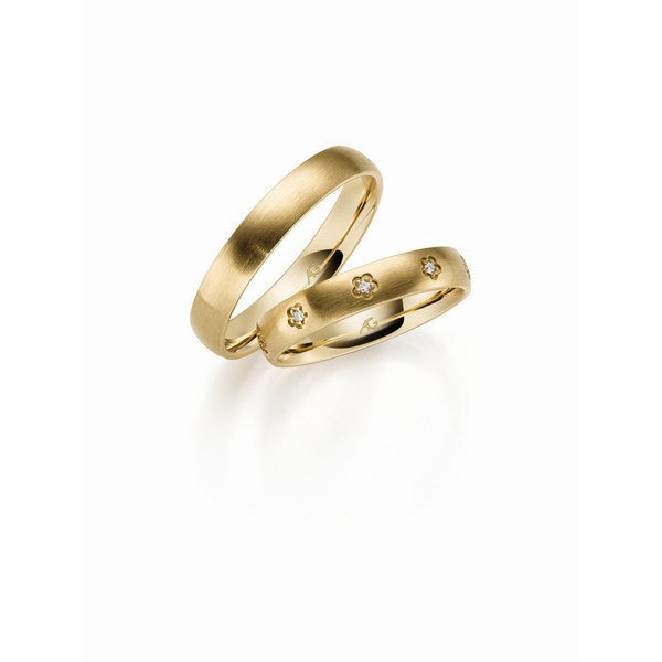 Gerstner vielsesringe i rødguld med blomsterformede diamanter i dameringen